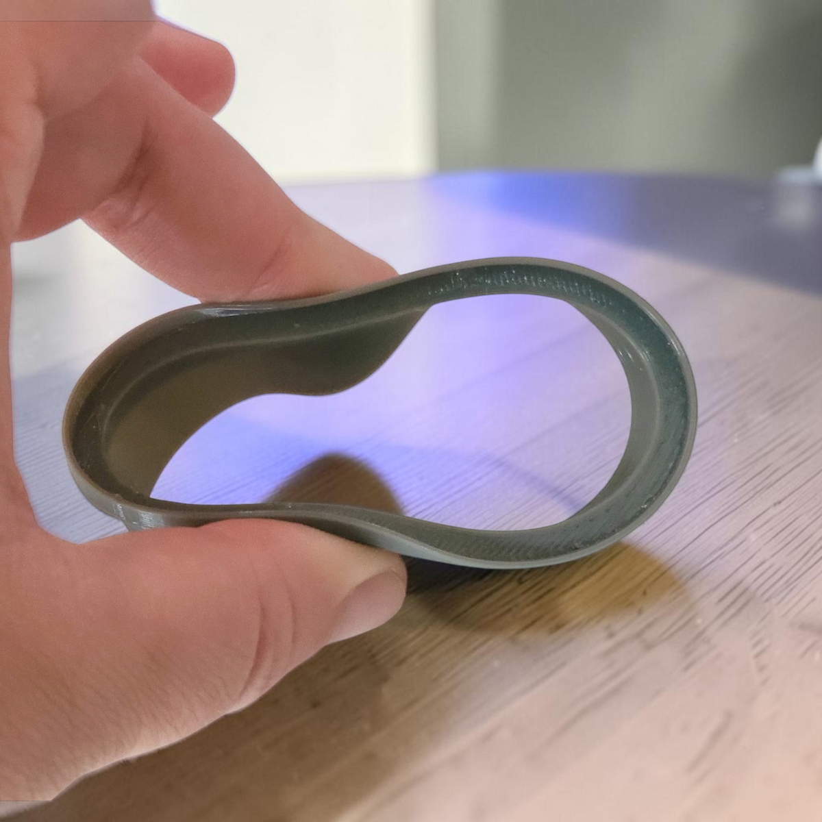 ARt flexible 82mm desert lid for GU jars being held and squeezed to demonstrate its durable TPU material