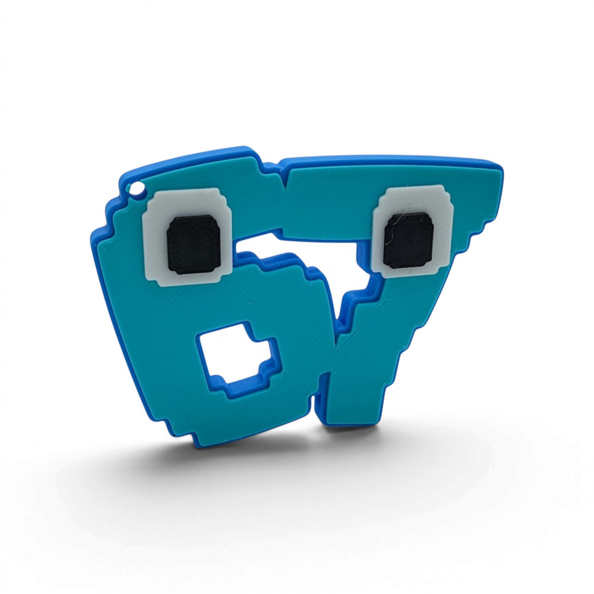 Blue pixel-style 67 brain rot character keyring with square black and white eyes, shown on white.