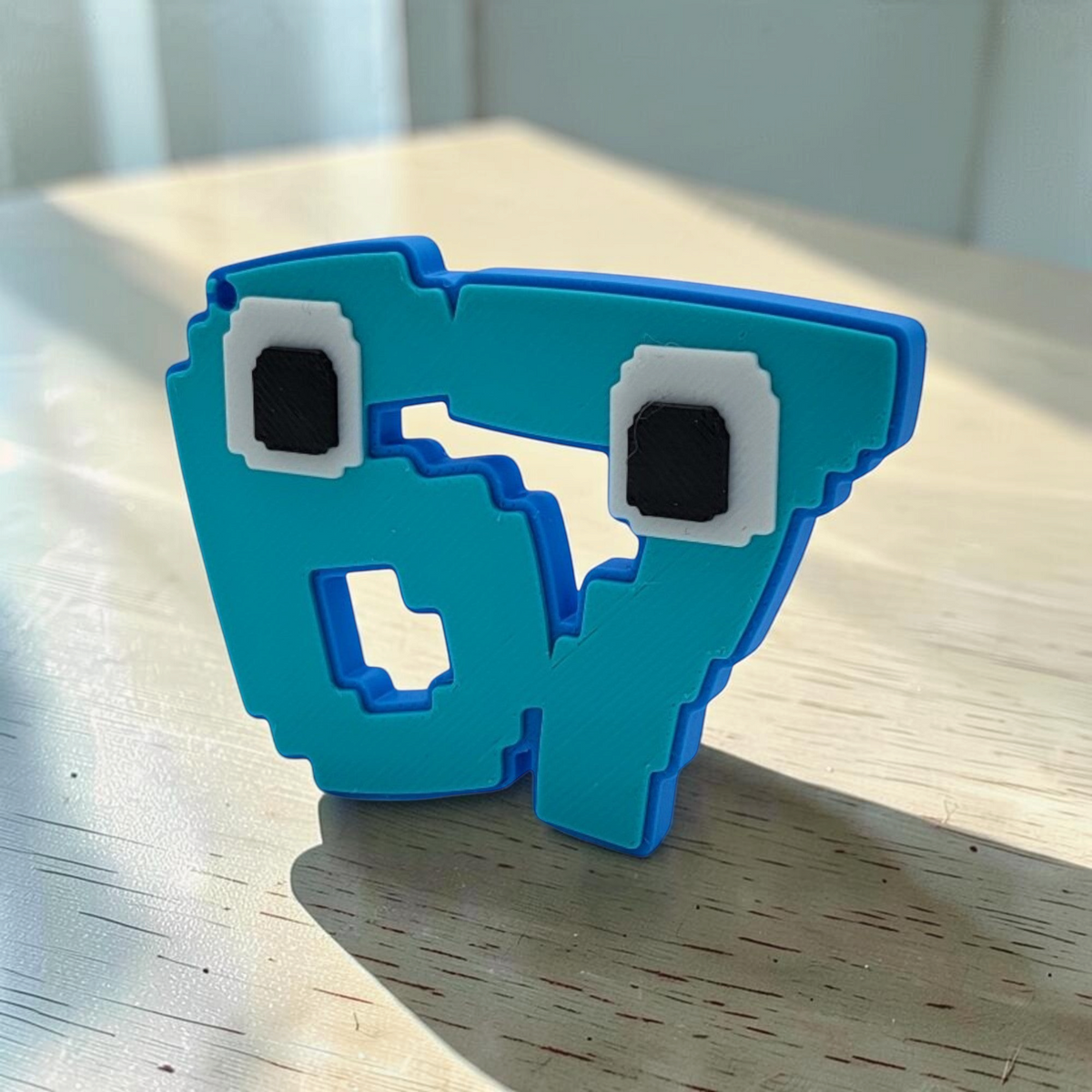 Blue 3D printed 67 brain rot character keyring shown at an angled view.