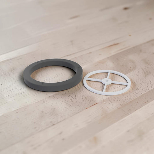 Black guide ring and white crosspiece for a camper van fresh water filler, shown on a wooden surface.