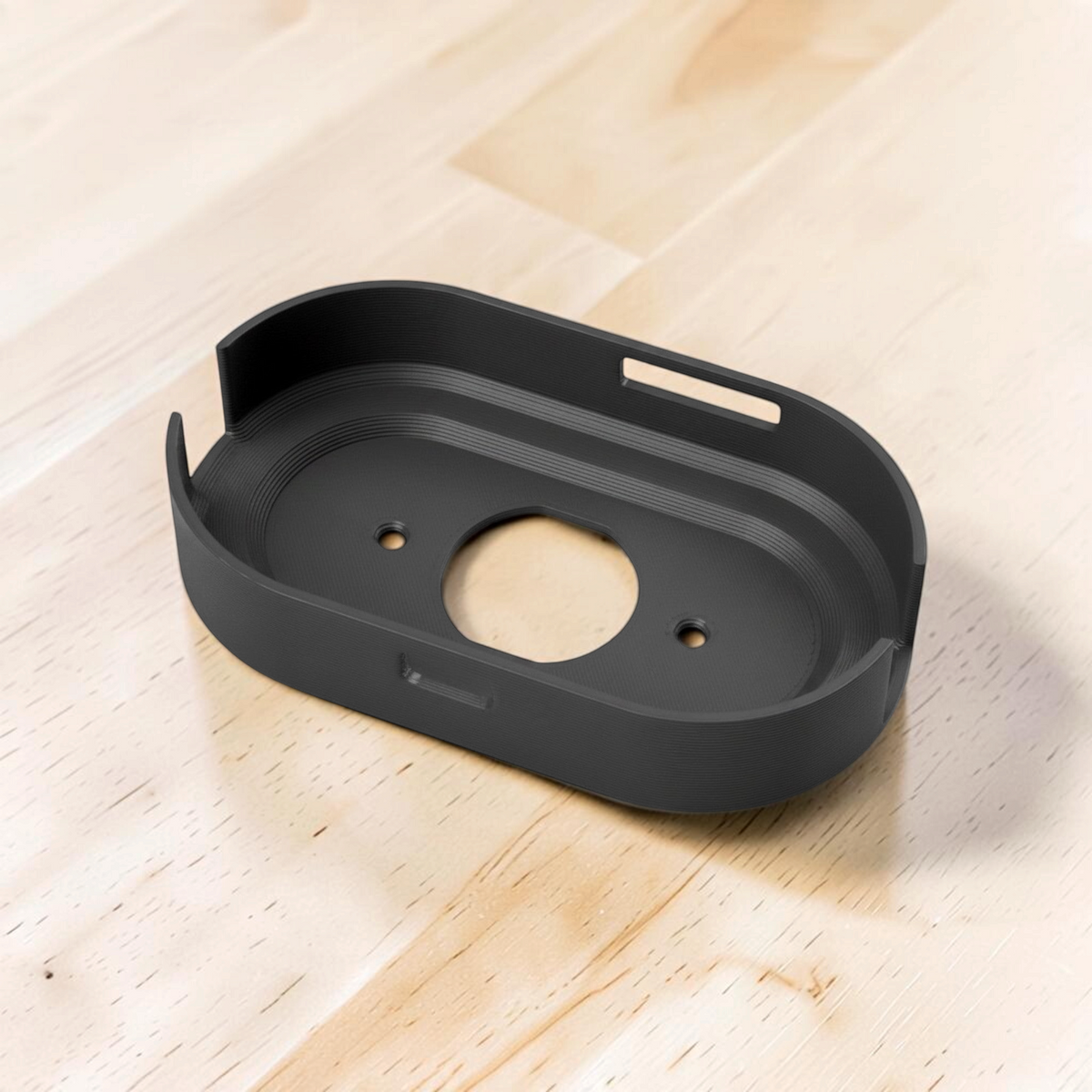 Black molded wall mount viewed from above, showing the router opening and mounting holes.