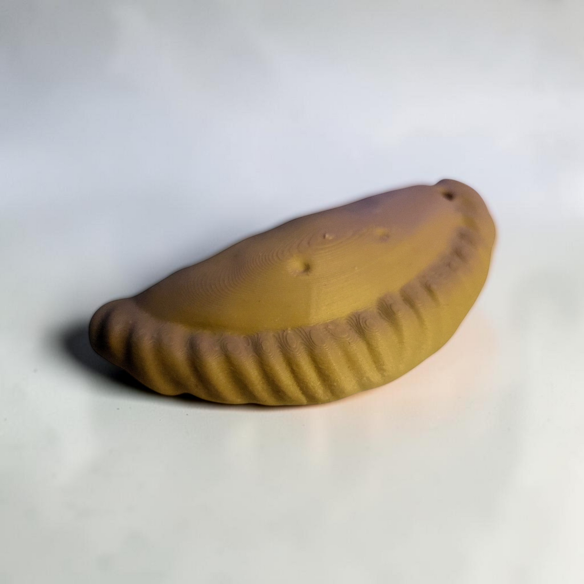 ARt Cornish Pasty Keyring in a golden-brown pastry colour with a realistic crimped edge design.