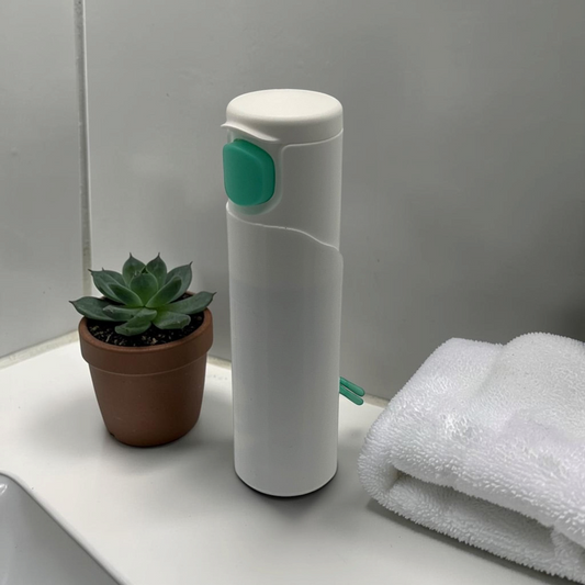 Compact discreet wipe case shown with the lid open and wipes inside, styled beside a small potted plant.