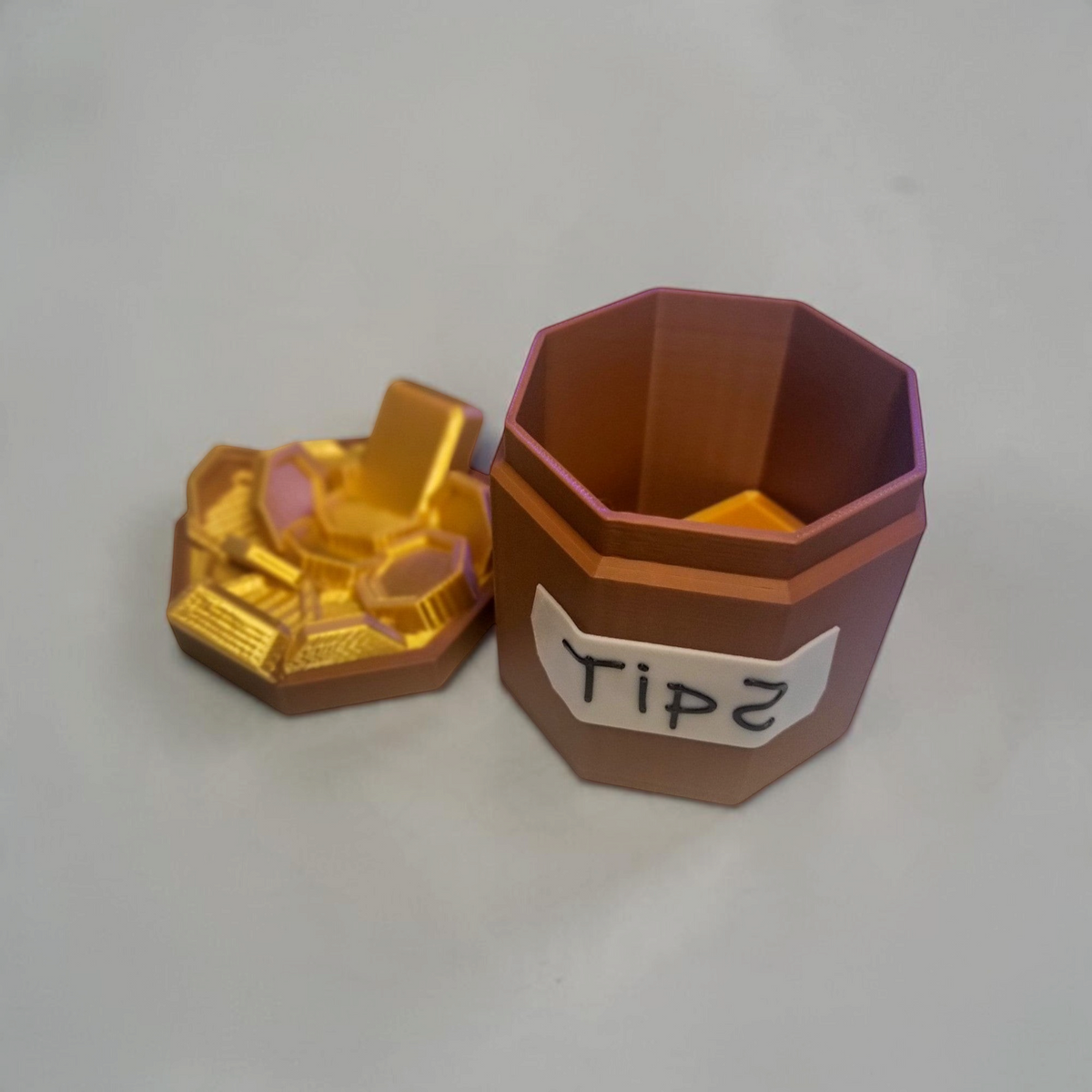 Doors Inspired bone and copper octagonal 3D printed tip jar with handwritten Tips label and gold coin embellishment on a wooden surface.