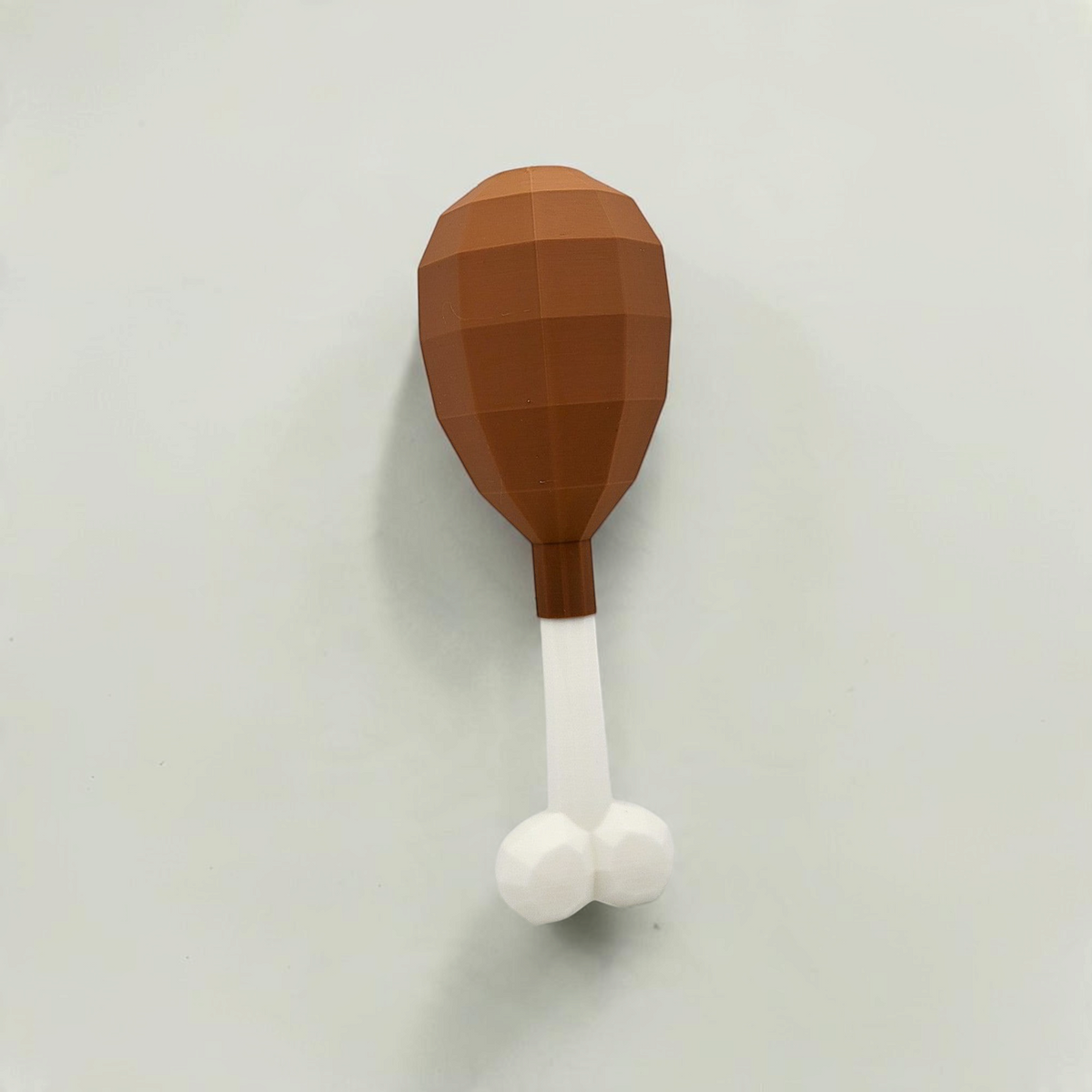 Front view of a brown turkey leg cosmetic fan art with a white bone on a white background