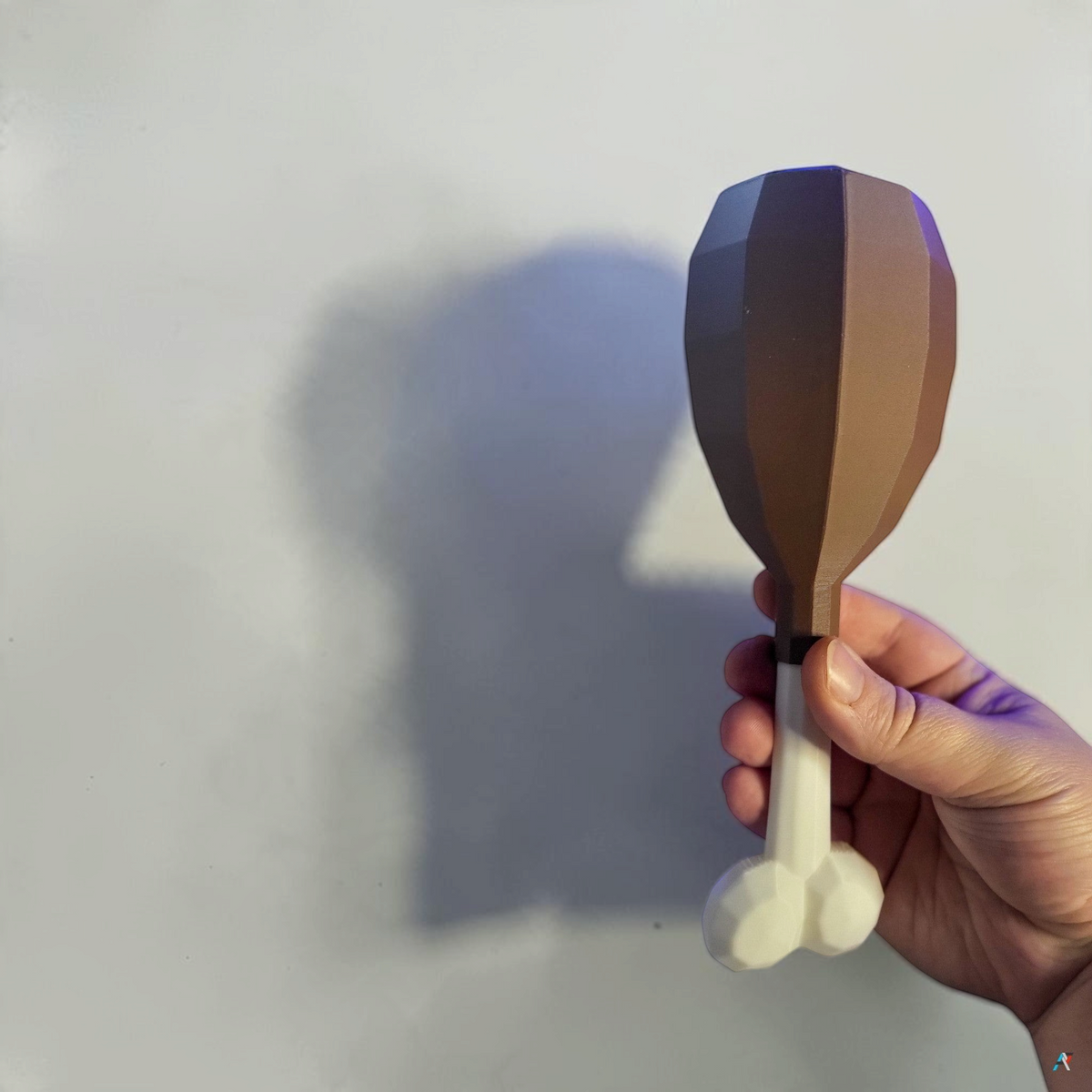 Hand holding a brown turkey leg cosmetic fan art with a white bone on a white background