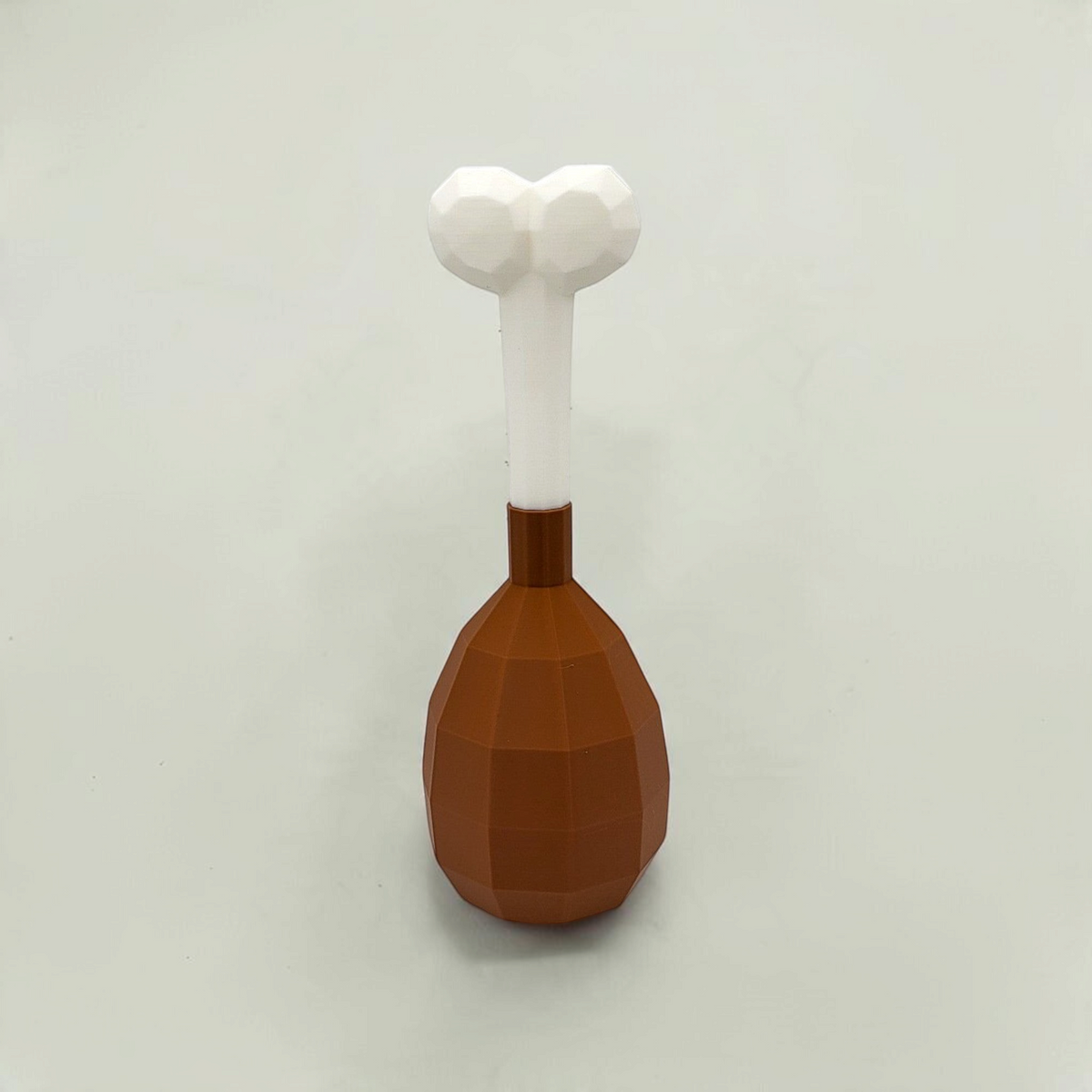 Upright brown turkey leg cosmetic fan art with a white bone on a white background