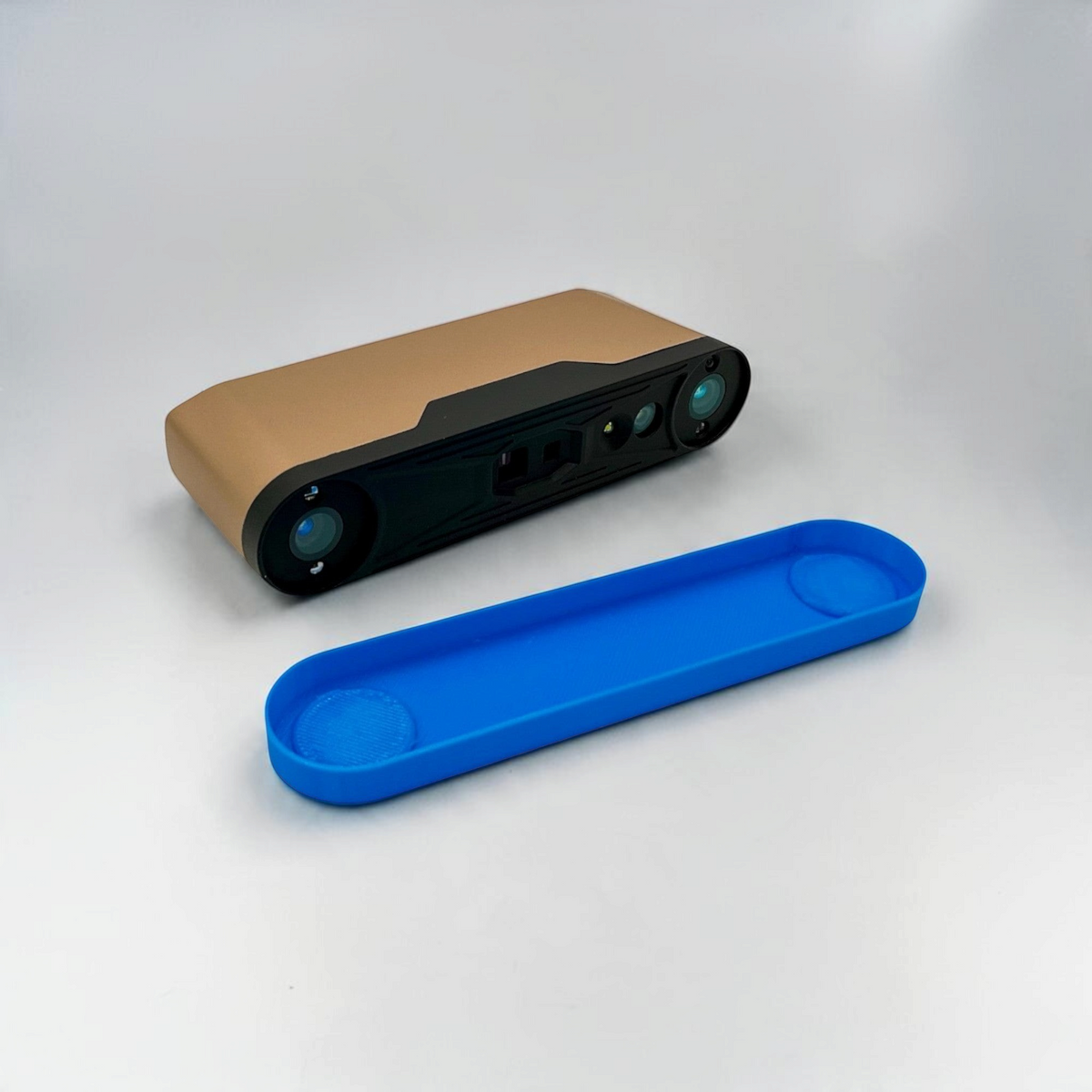 Blue flexible TPU protective cover shown beside a handheld 3D scanner on a white background.