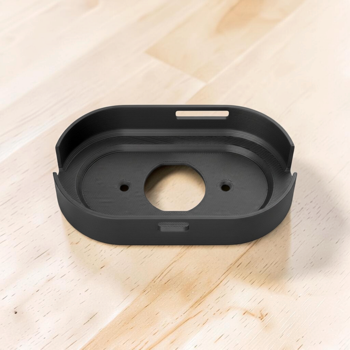Rear view of the black Wi-Fi router wall mount with central opening and screw holes.