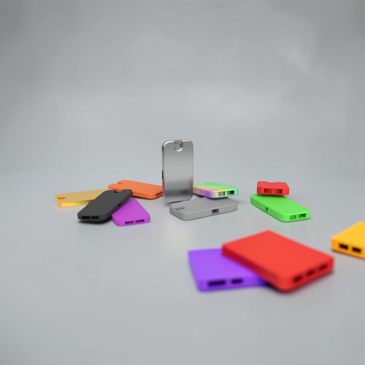 Colourful flat pocket whistle keychains shown in assorted finishes.